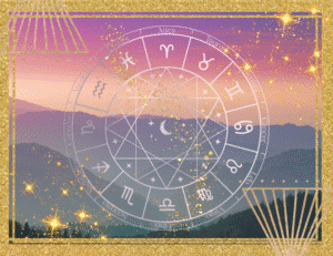 a gold zodiac wheel with dark mountains in the distance during sunset