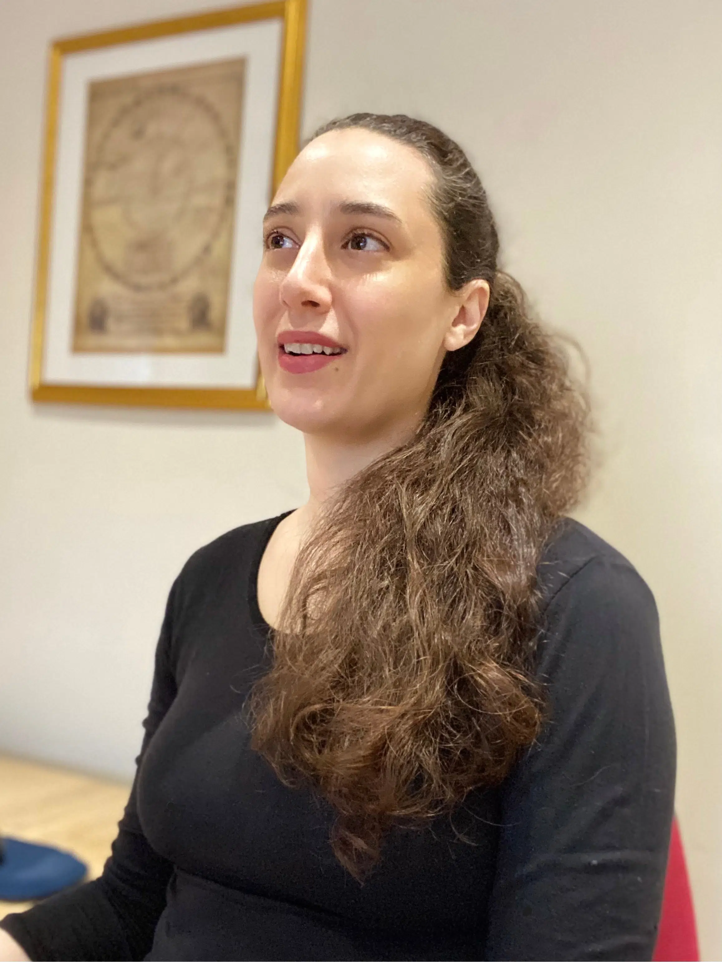 Diana Zannis smiling and laughing wearing black in her office