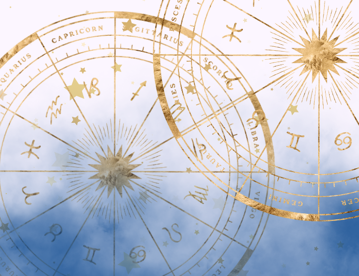 two gold zodiac wheels floating in dark blue smoke